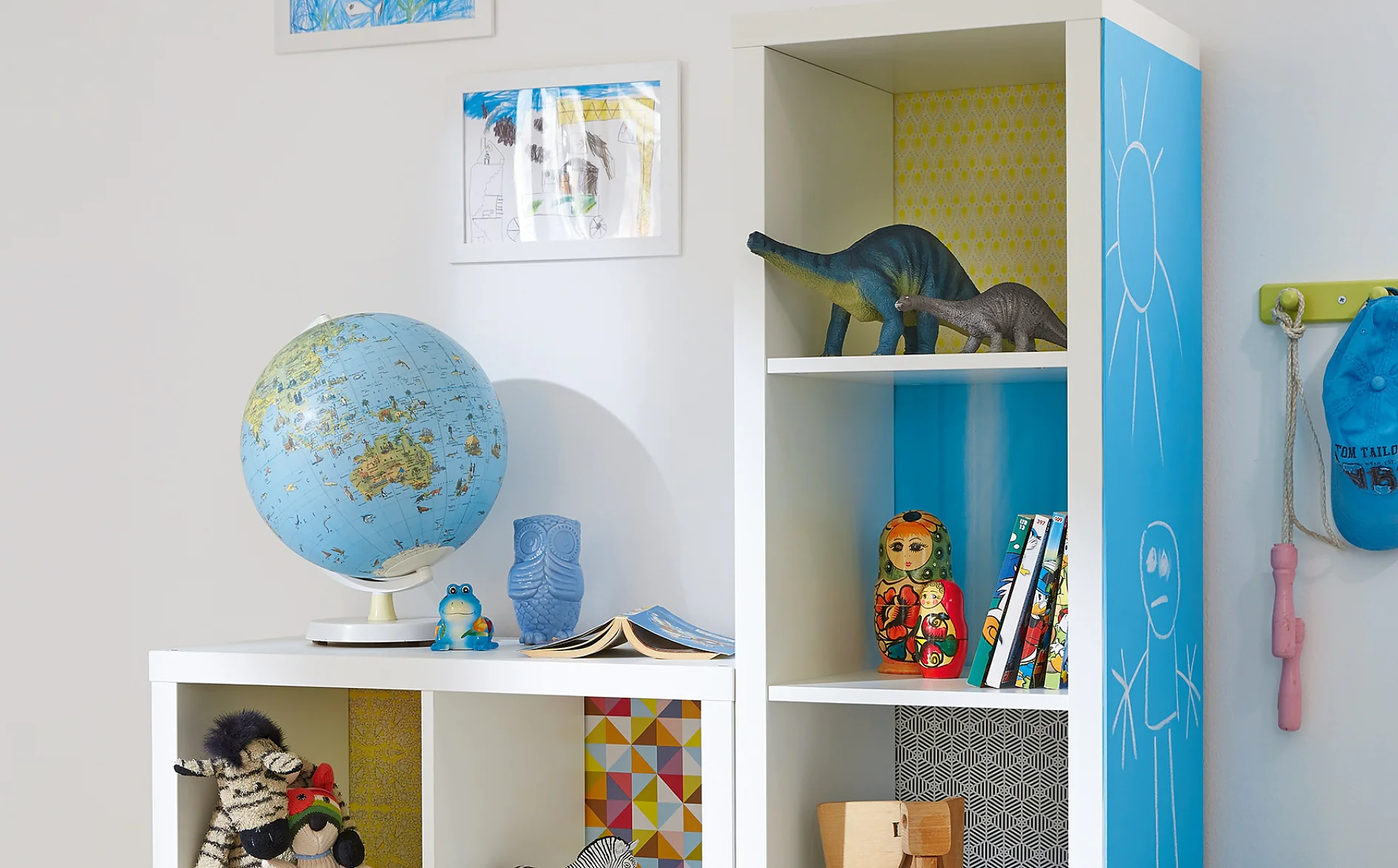 Here's an idea that kids will love. Each shelf has its own background, using decorative paper, stuck with tesa® Spray Glue PERMANENT, and on the side of the unit, there's a big blackboard so they're free to write or paint.