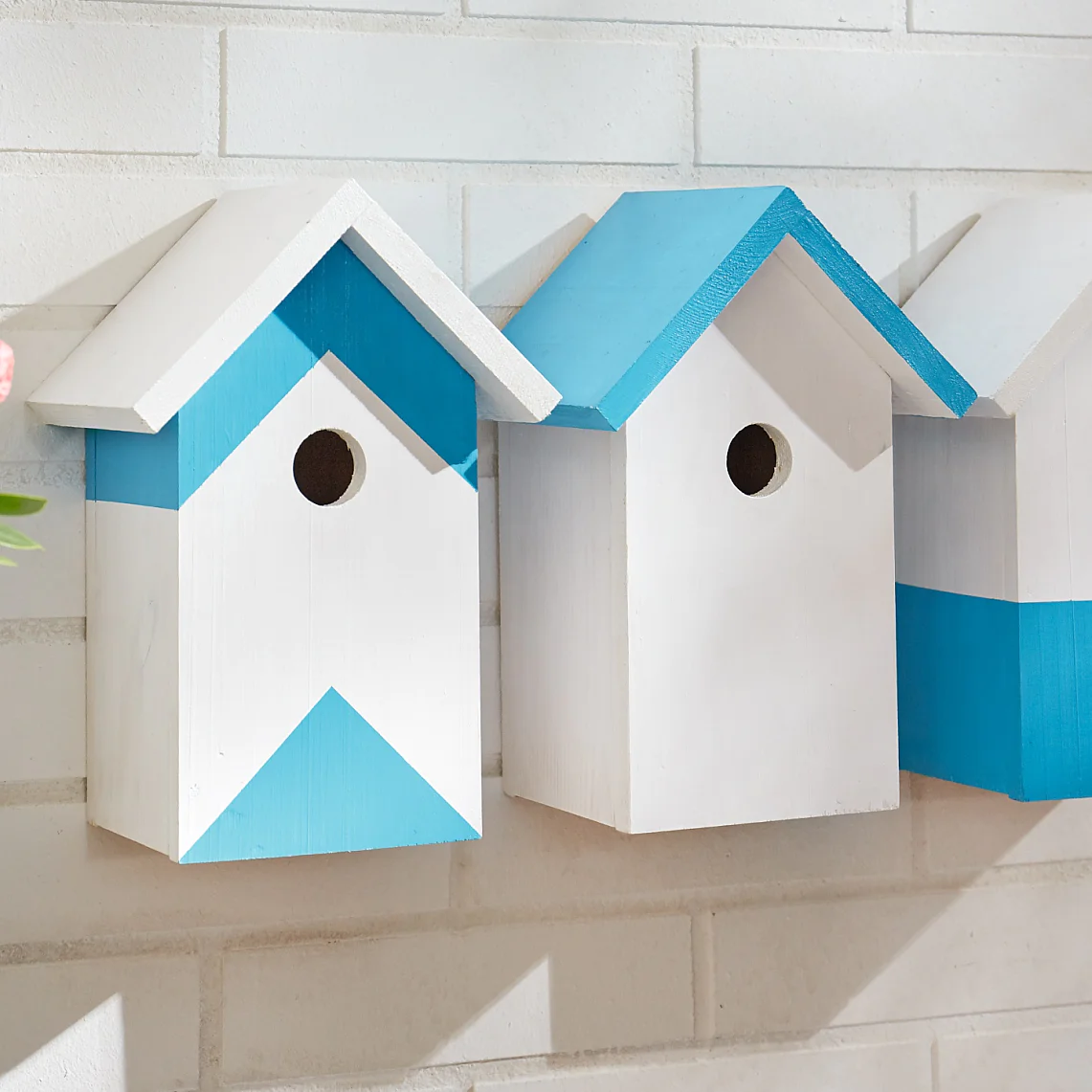 Create a row of stylish wooden bird houses