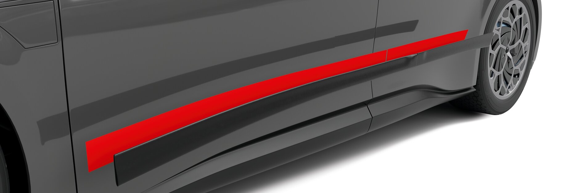 Gros plan sur une voiture grise élégante avec une bande rouge proéminente traversant horizontalement le côté. La voiture possède des roues modernes et stylisées ainsi qu'une carrosserie lisse, mettant en valeur son aspect sportif.
