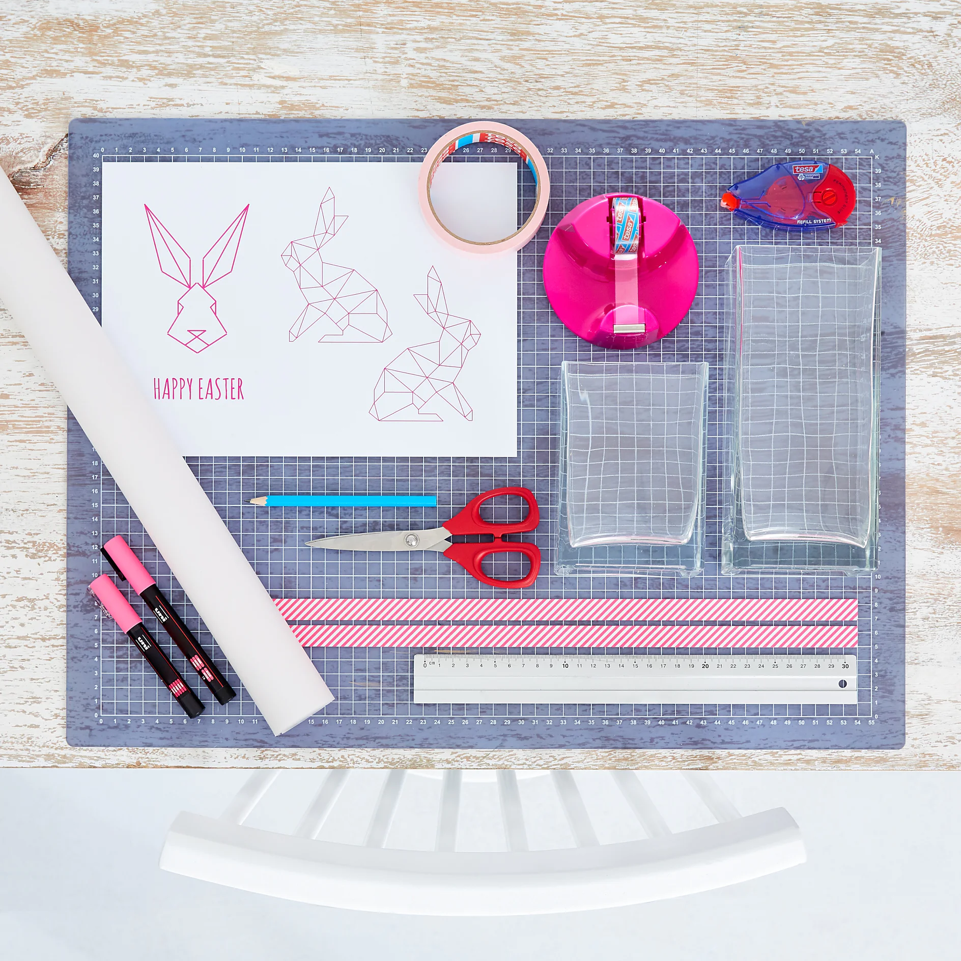 We need: 
Printed bunny template, sturdy tracing paper, neon pink chalk pen, scissors, pencil, ruler, paper strip with neon pattern (1.5 cm wide), square glass lanterns, tesa® Masking Tape for Wallpaper, tesa Glue Roller Permanent ecoLogo®, tesa Easy Cut® Compact Desk dispenser + tesafilm® crystal clear.
Time: approx. 15 minutes per Easter Light