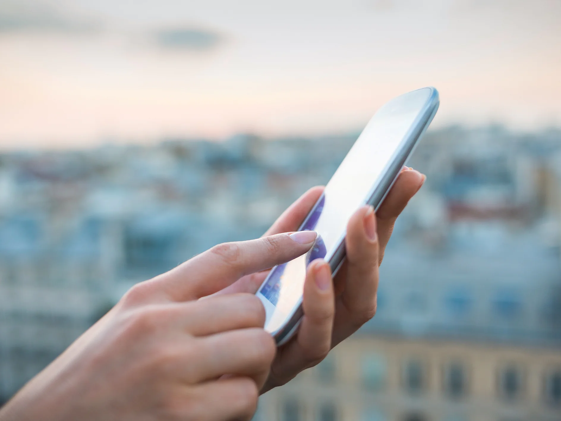 tesa woman using smartphone with city background