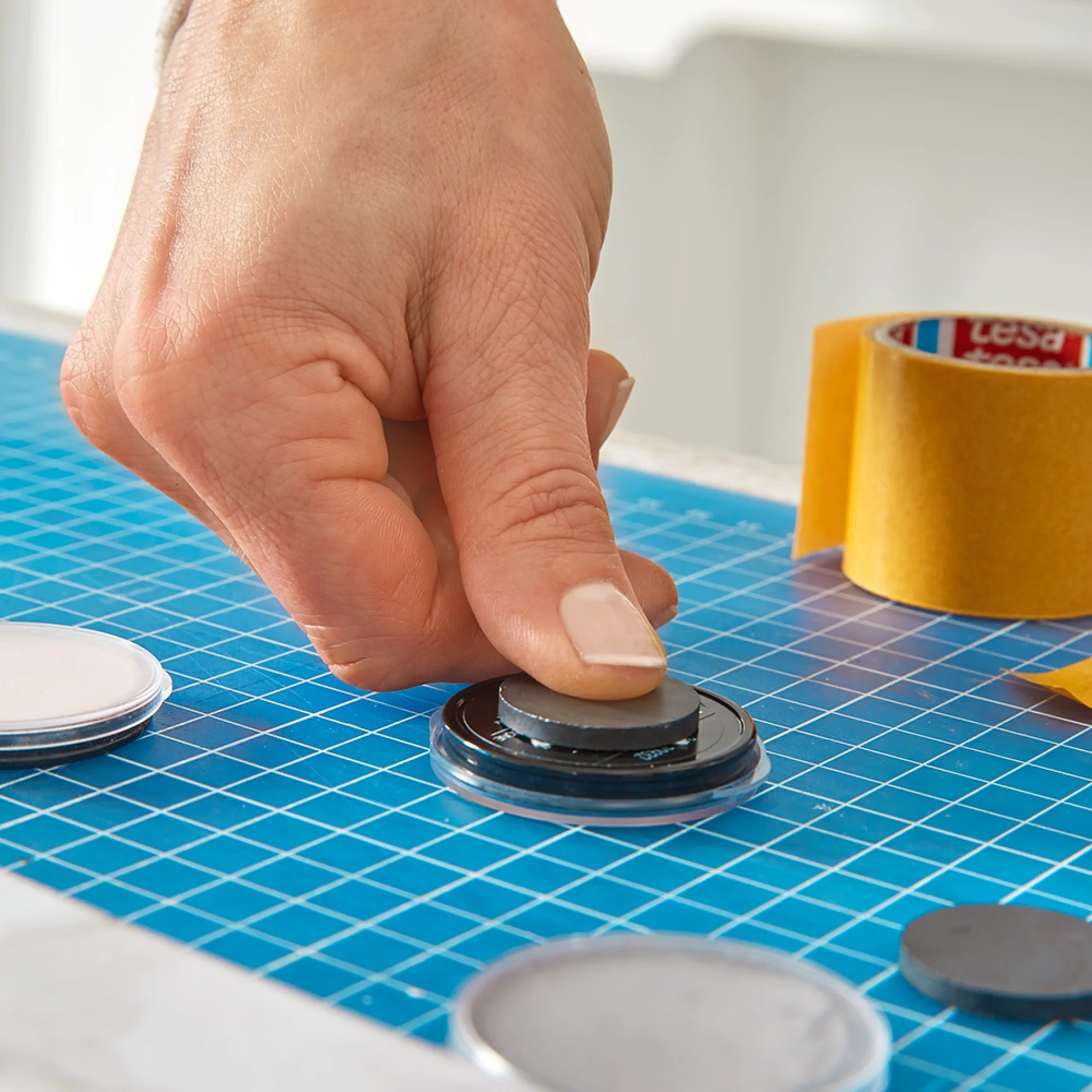 Mounting magnets on products when making a make-up organiser.