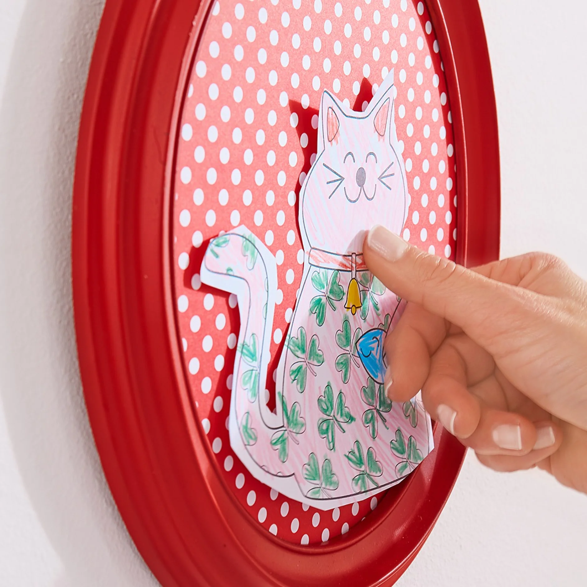 Mounting children’s art work in frames when making a DIY gallery wall using double-sided adhesive pads for transparent & glass.