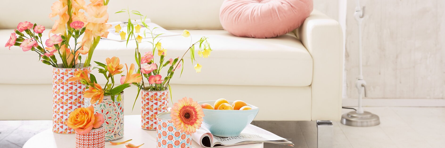 Simple white tin cans hide under the cheerful fabric patterns on the vases. They are quick and easy to make, so you might even make a few more for your friends ...