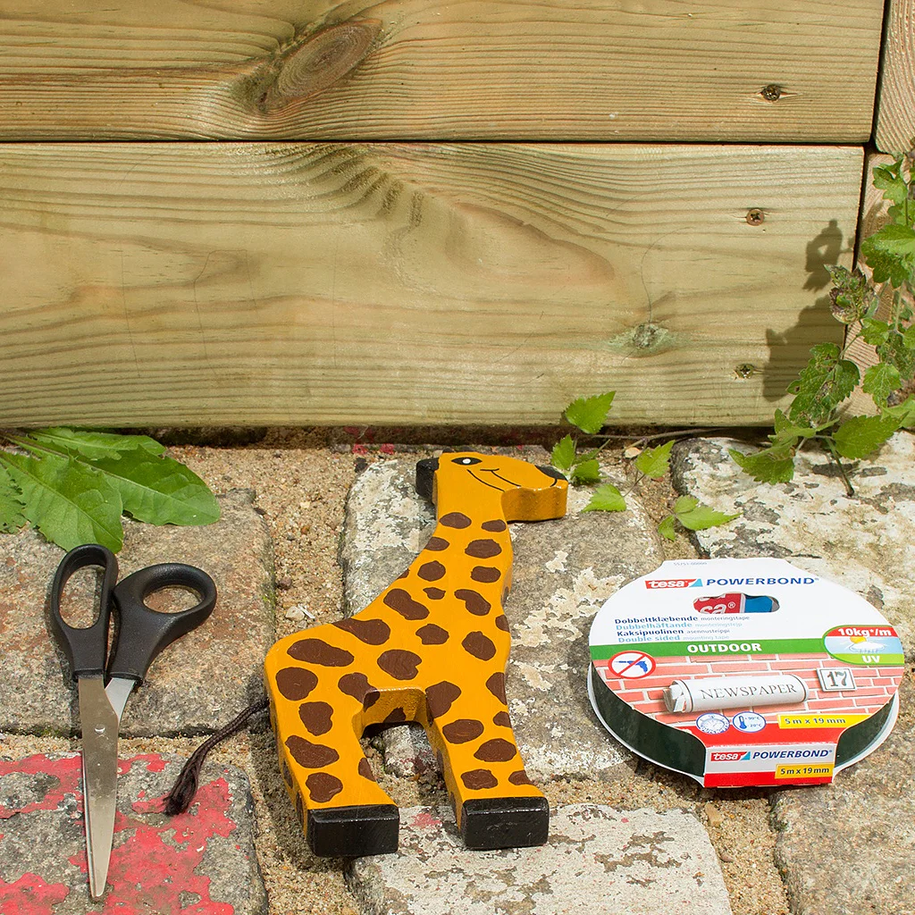 Scissors, wooden animal and tesa Powerbond® OUTDOOR adhesive tape.