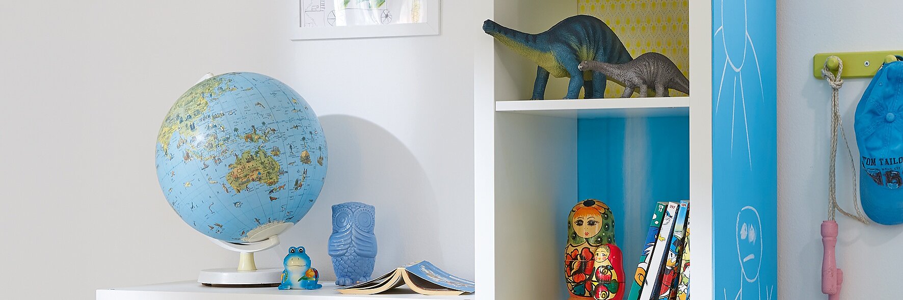 Here's an idea that kids will love. Each shelf has its own background, using decorative paper, stuck with tesa® Spray Glue PERMANENT, and on the side of the unit, there's a big blackboard so they're free to write or paint.