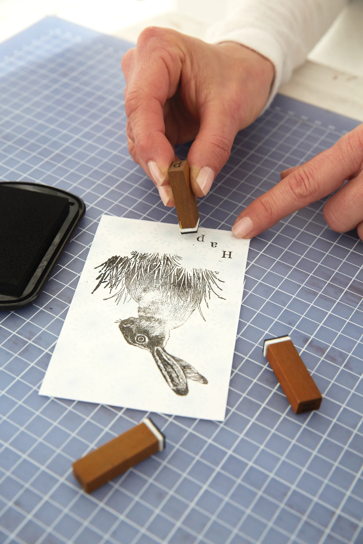 Using the letter stamps, write "Happy Easter" on the pouch.