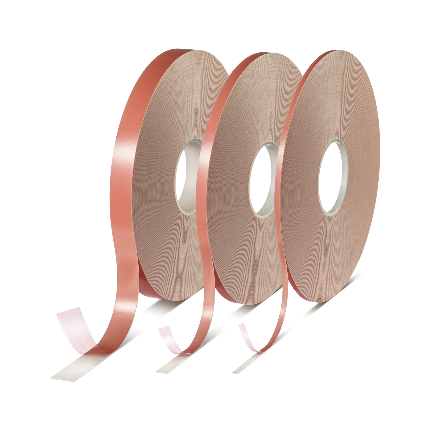 Three large rolls of copper tesa tape are standing upright side by side. Each roll has a shiny copper surface with adhesive backing visible at the ends. The tesa tape is partially unrolled, showing its thin and flexible nature. (This text has been generated by AI)