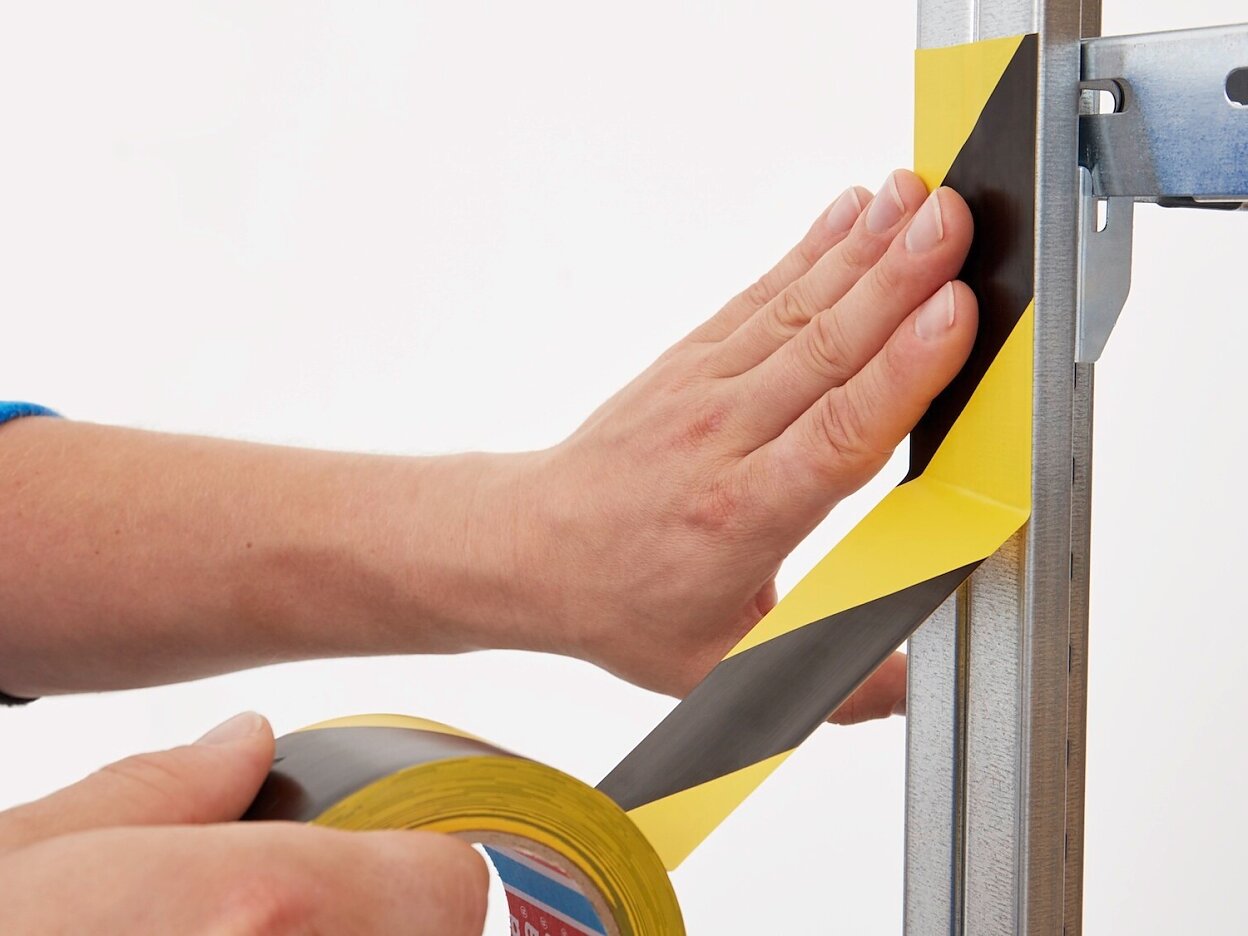 tesa-60760-soft-pvc-floor-marking-hazard-tape-black-yellow-step2of4-ap