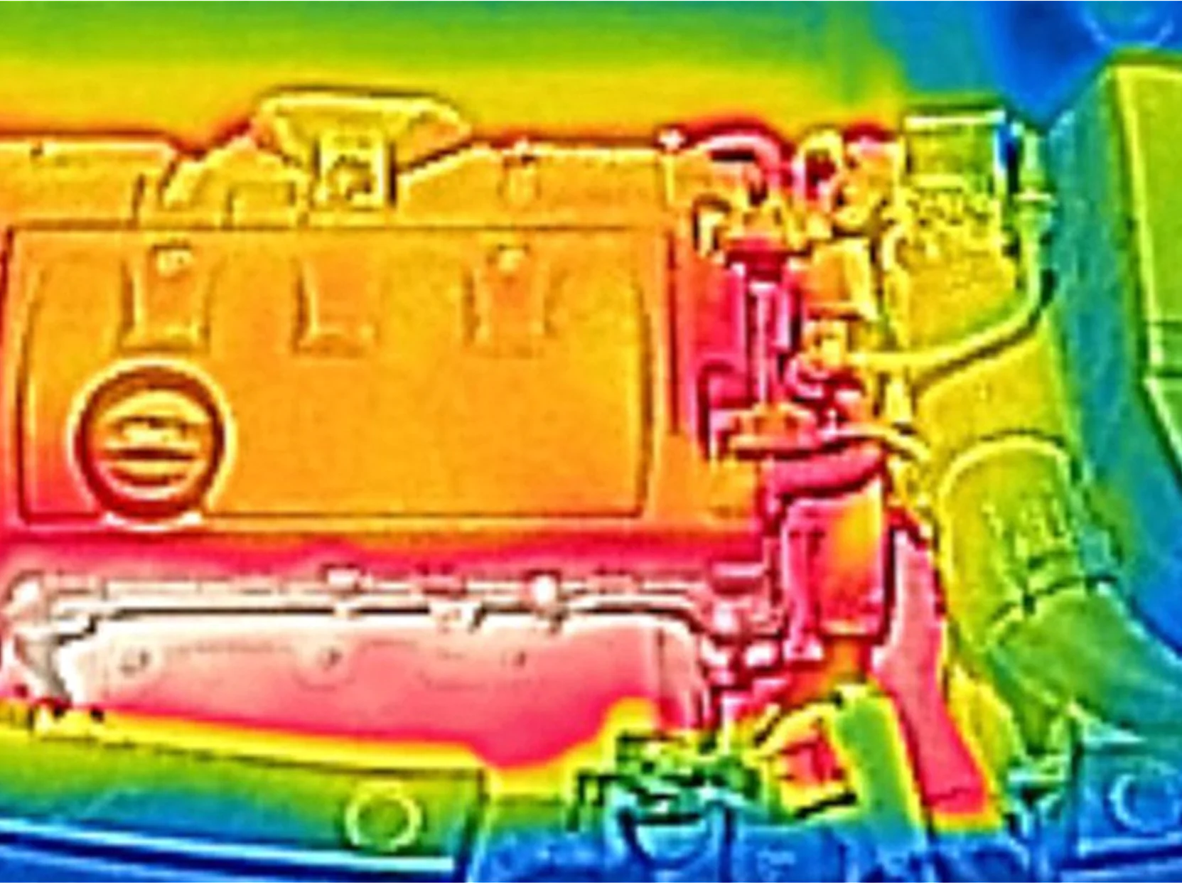 Thermal image of a car engine. The engine appears in warm colors, predominantly red and orange, indicating heat. Cooler colors, such as blue and green, surround the engine, suggesting lower temperatures in those areas. (This text has been generated by AI)