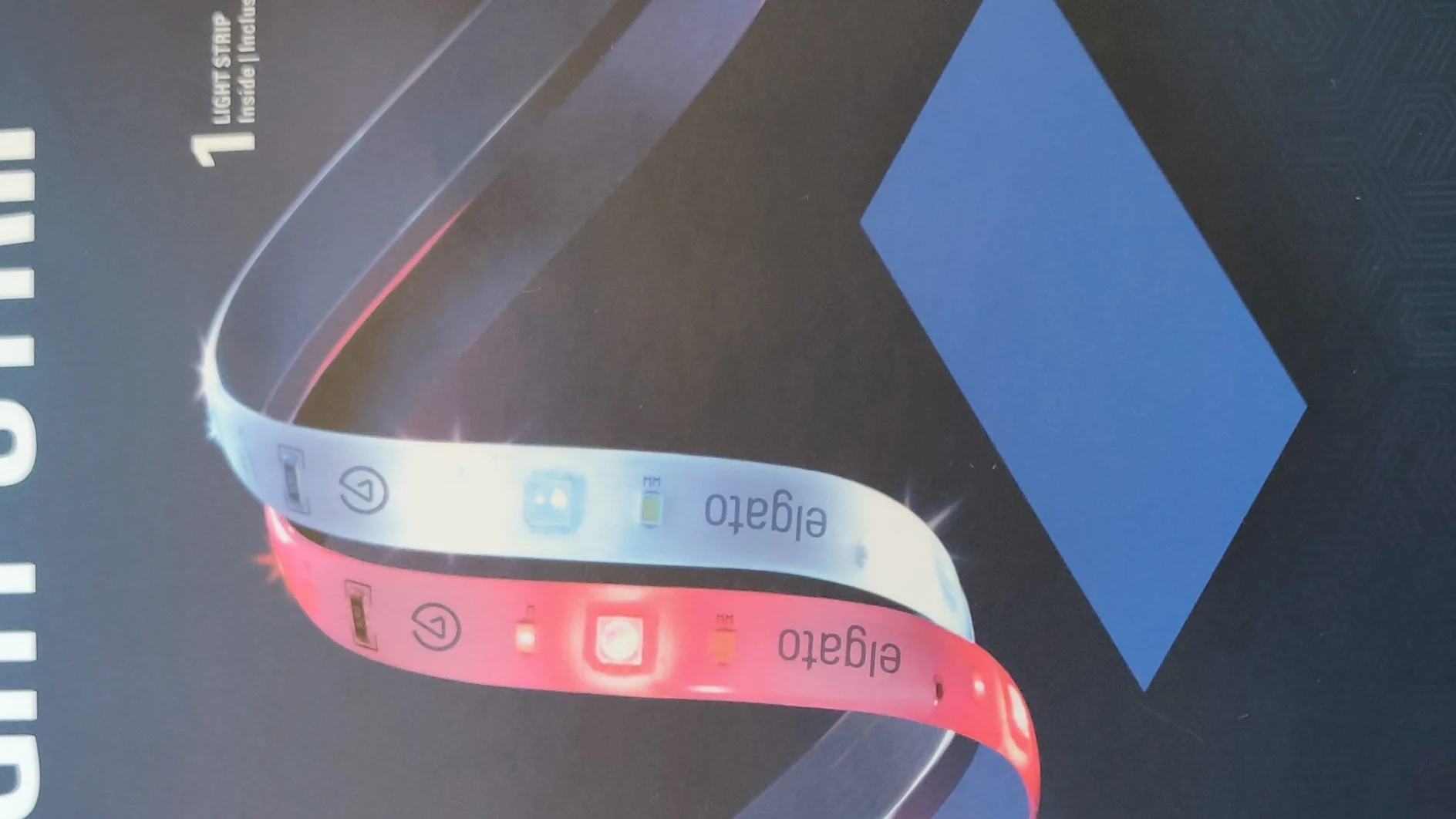 Image of a product packaging for a light strip. The box features an image of a multicolored LED strip with RGB lighting effects. Text on the box includes Light Strip and ILLUMINATE ON COMMAND PILOTEZ VOTRE ÉCLAIRAGE. The brand name elgato is visible, and the package highlights its compatibility with tesa tape for easy installation. (This text has been generated by AI)