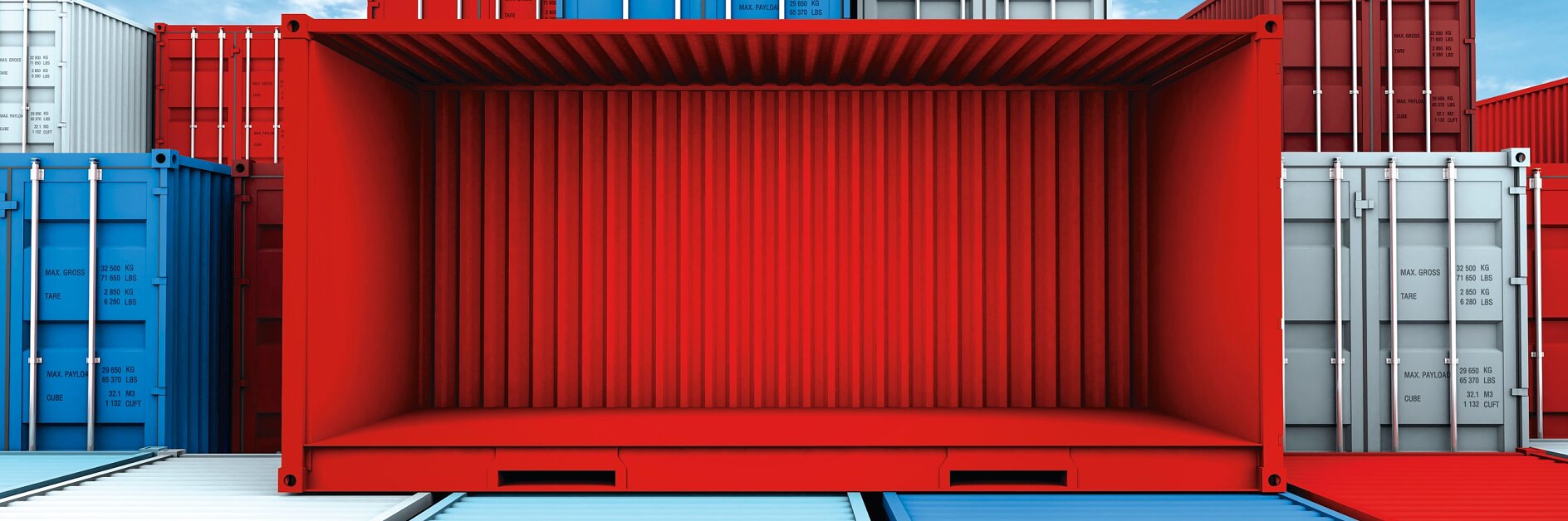 A stack of colorful shipping containers against a blue sky, with a prominent red container in the center that is open on the front side. Other containers in blue and white are visible around it.
