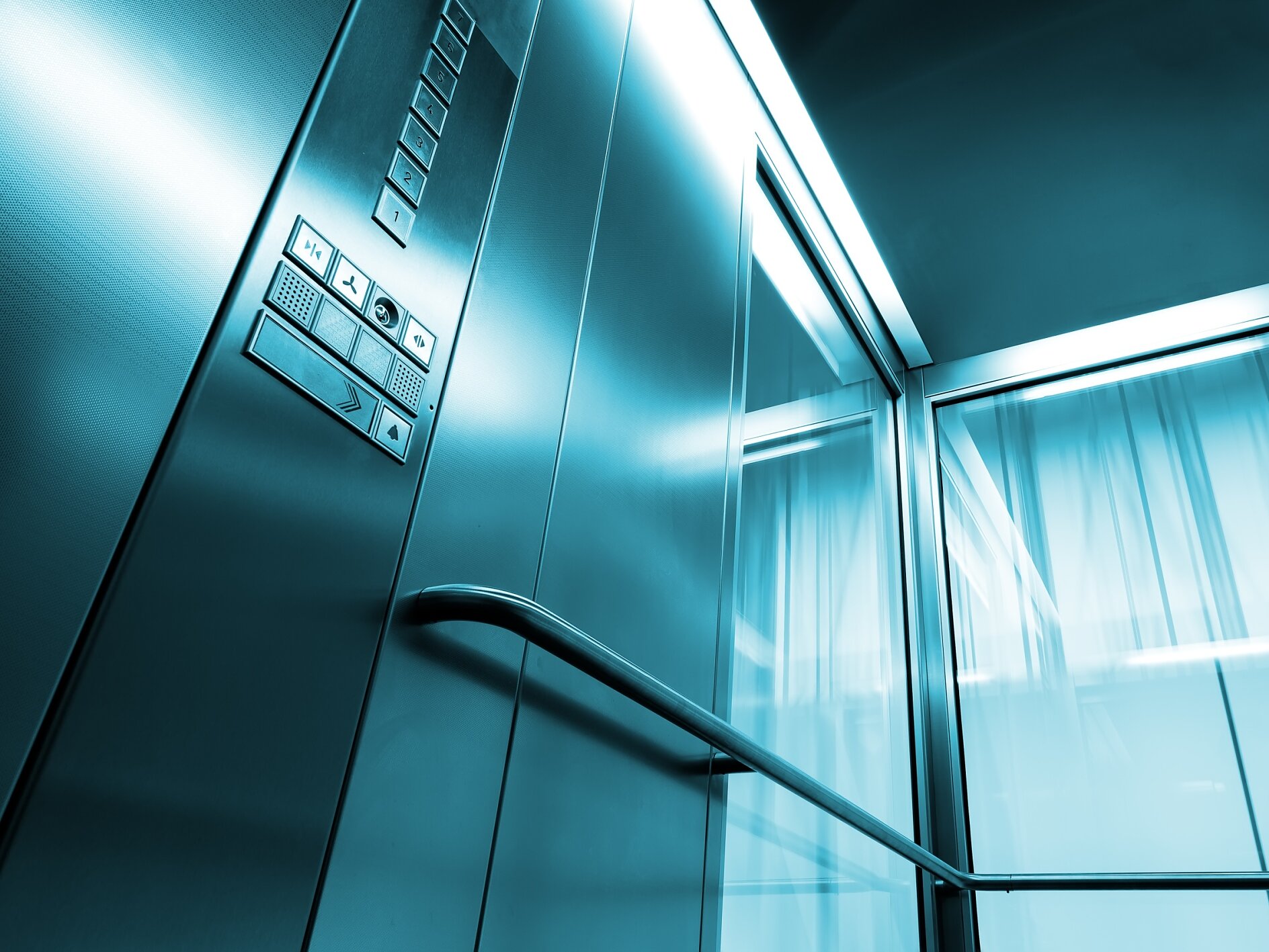 Inside metal and glass Elevator in modern building , the shiny buttons and railings Inside metal and glass Elevator in modern building , the shiny button railings
