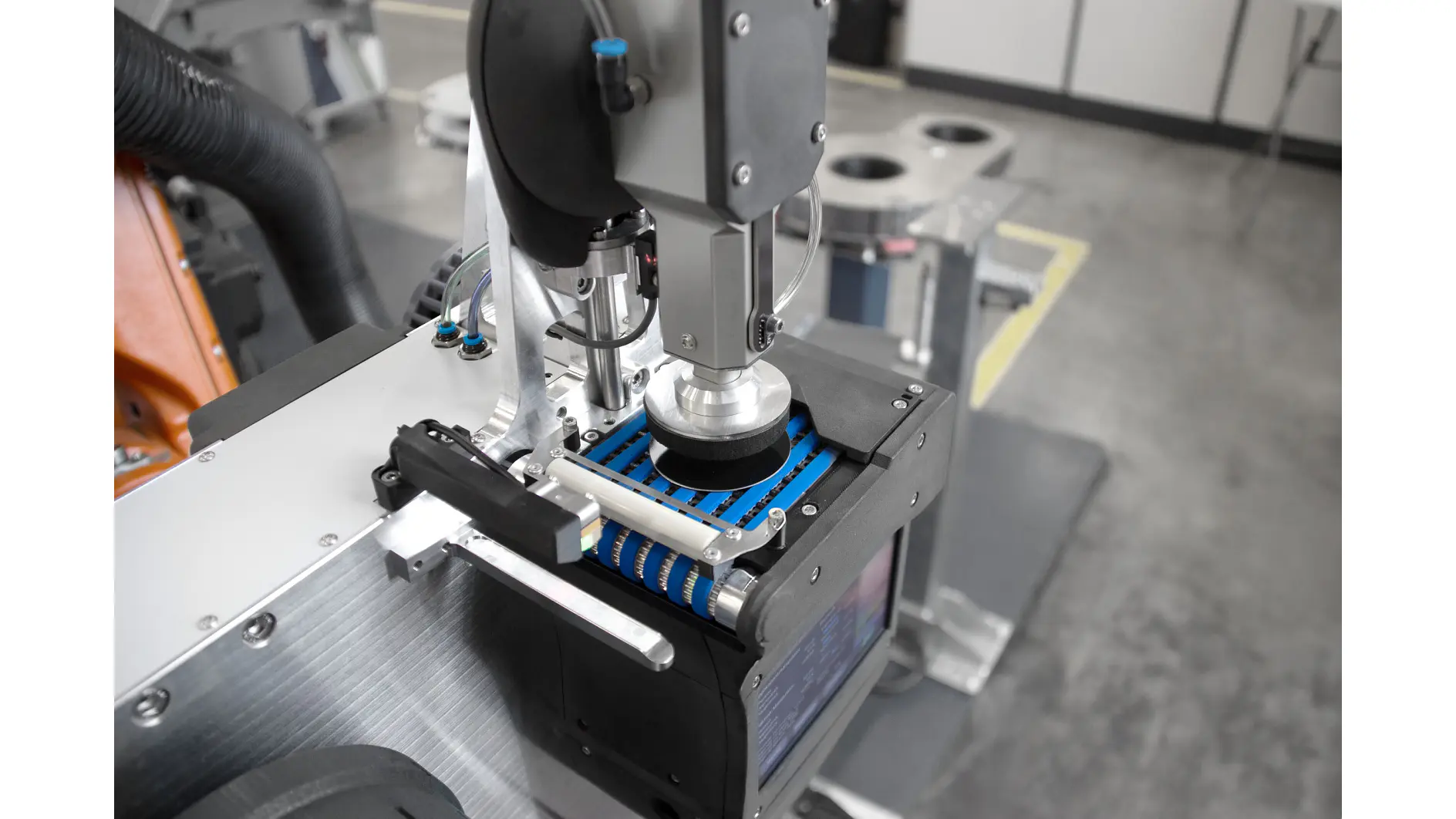 tesa industrial machine applying adhesive tape on a metal component in a clean factory setting (This text has been generated by AI)