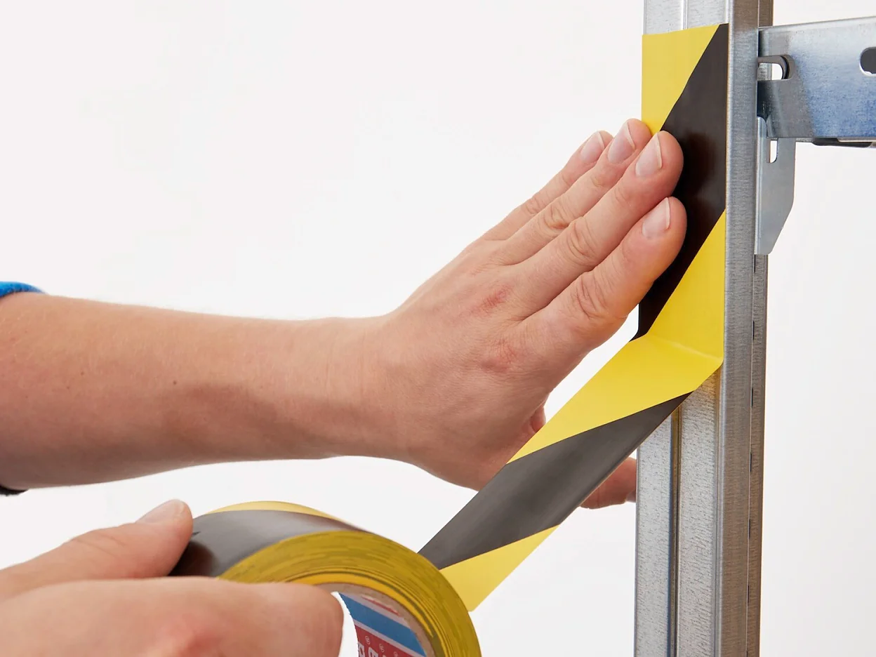 tesa-60760-soft-pvc-floor-marking-hazard-tape-black-yellow-step2of4-ap