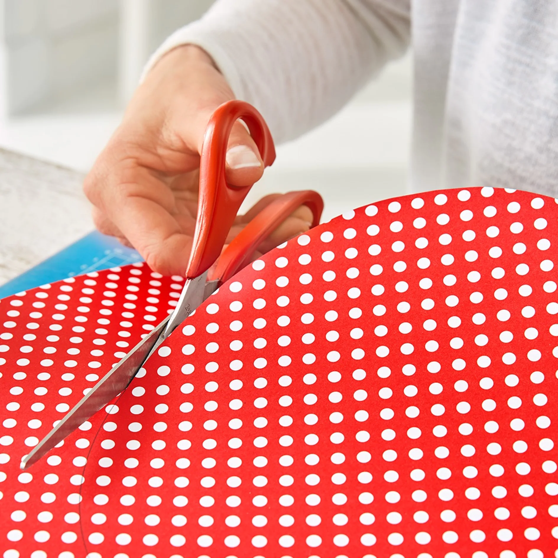 Cutting out art backgrounds from patterned paper when making a DIY gallery wall