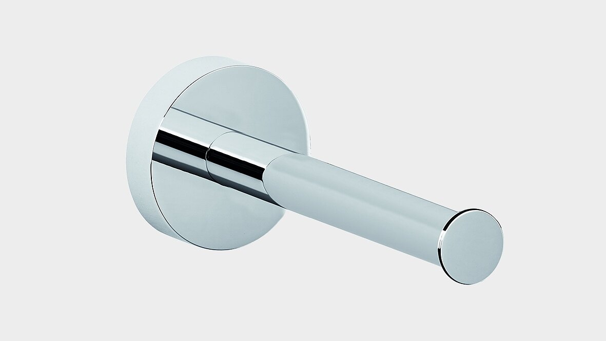 Wall-mounted chrome toilet paper holder with a cylindrical arm and round base against a plain white background, installed using tesa tape. (This text has been generated by AI)