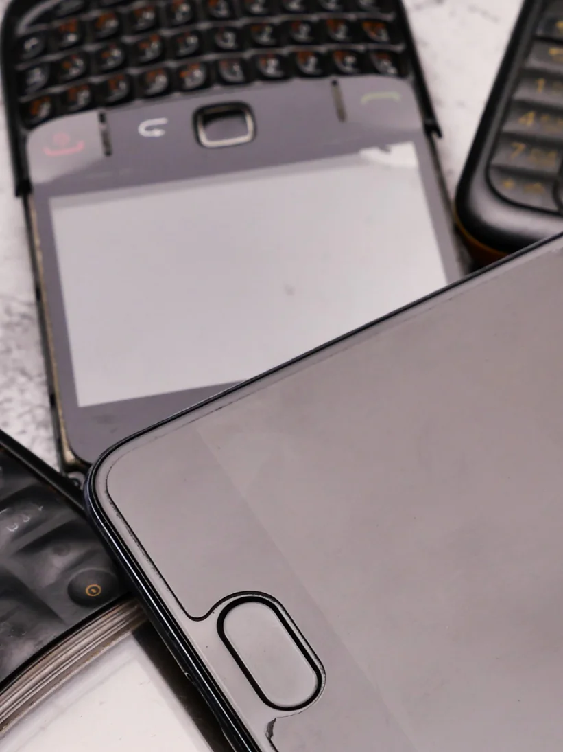 A smartphone on pile of obsoleted cellphones.