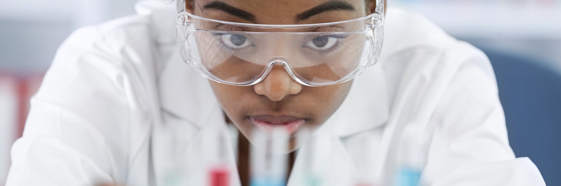 woman with glasses holds samples in her hands