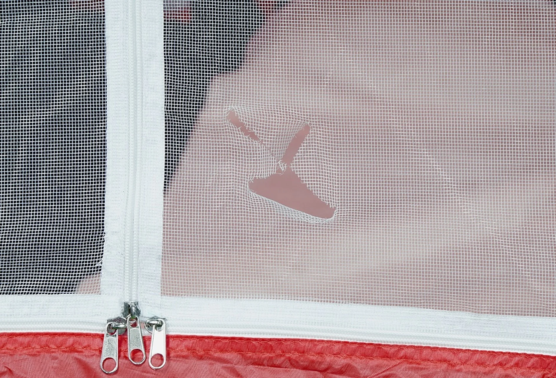 A red and white tent with a mesh window is shown. The mesh has a small tear with a patch of tesa tape applied over it. Two zippers are located at the bottom of the mesh. (This text has been generated by AI)