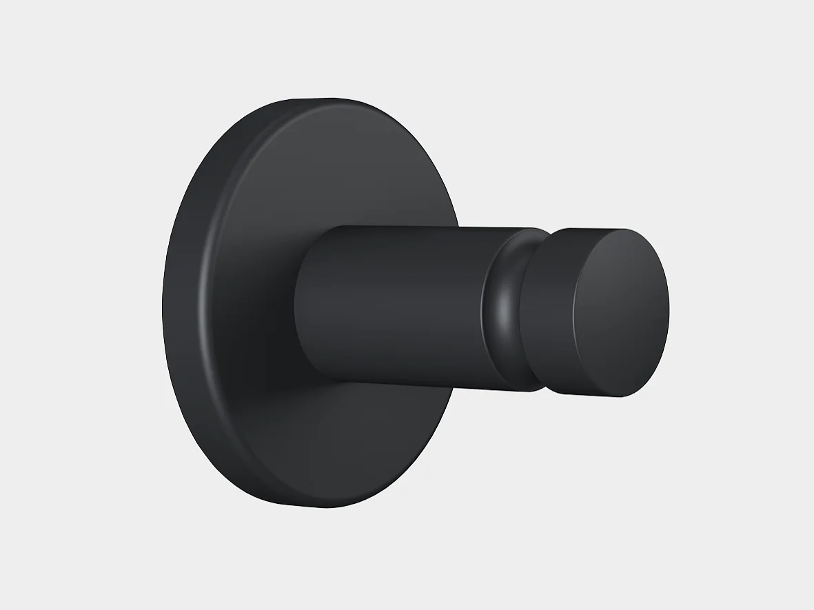 Um gancho de parede preto fosco com uma base redonda e um pino cilíndrico, montado com fita tesa, mostrado contra um fundo cinza claro simples. (This text has been generated by AI)