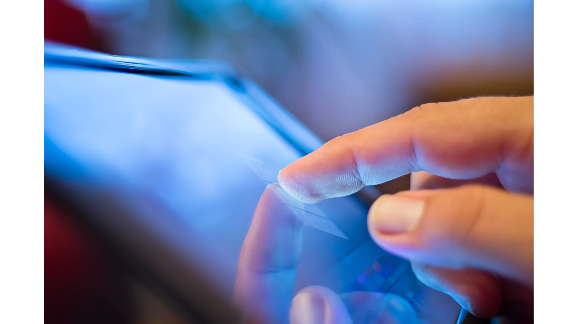 A close-up of a persons finger tapping on a touchscreen device, possibly a tablet or smartphone. The screen emits a blue light, and the background is blurred. (Acest text a fost generat de inteligența artificială)