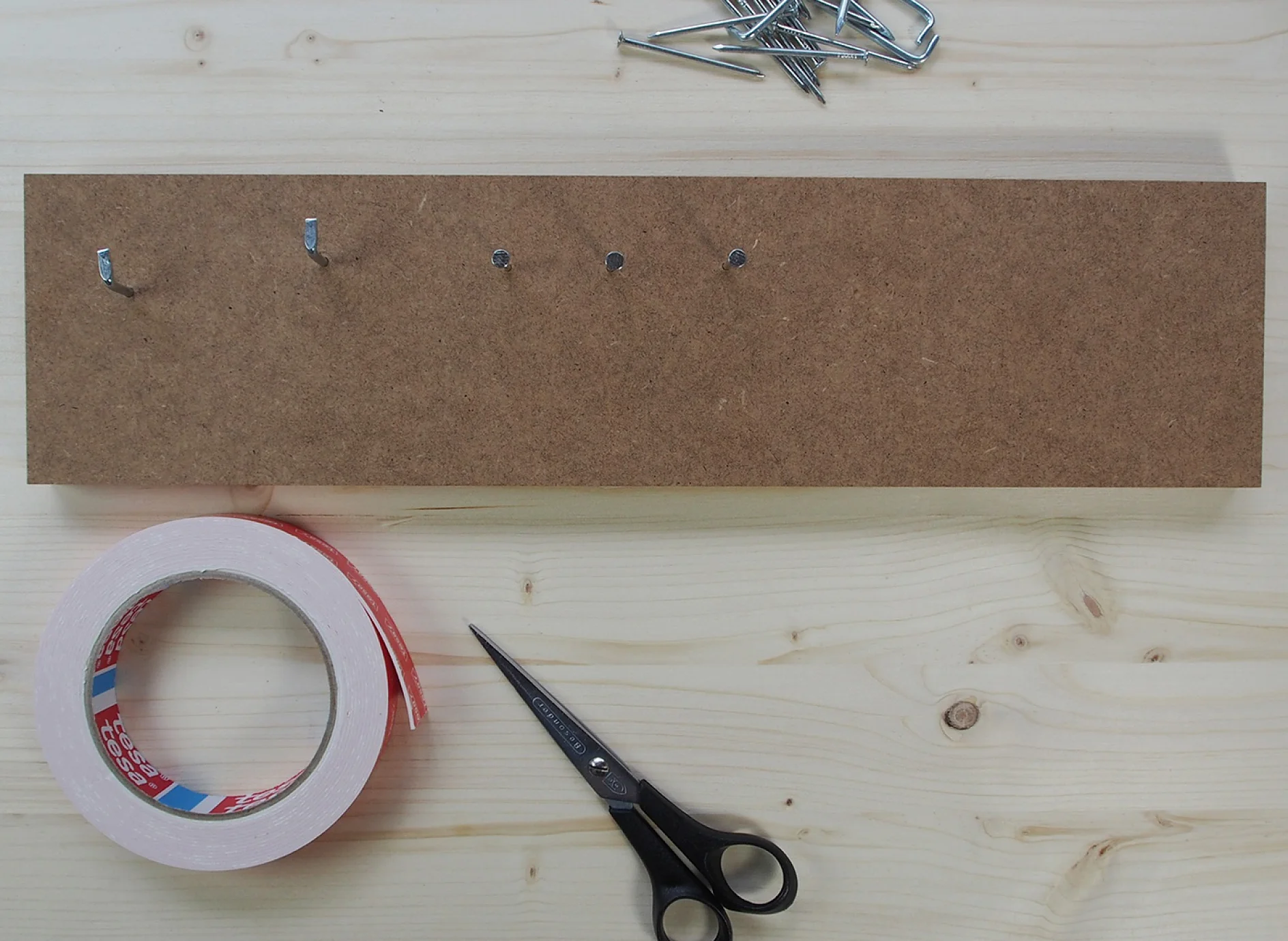 Image of nails hammered into wood MDF.