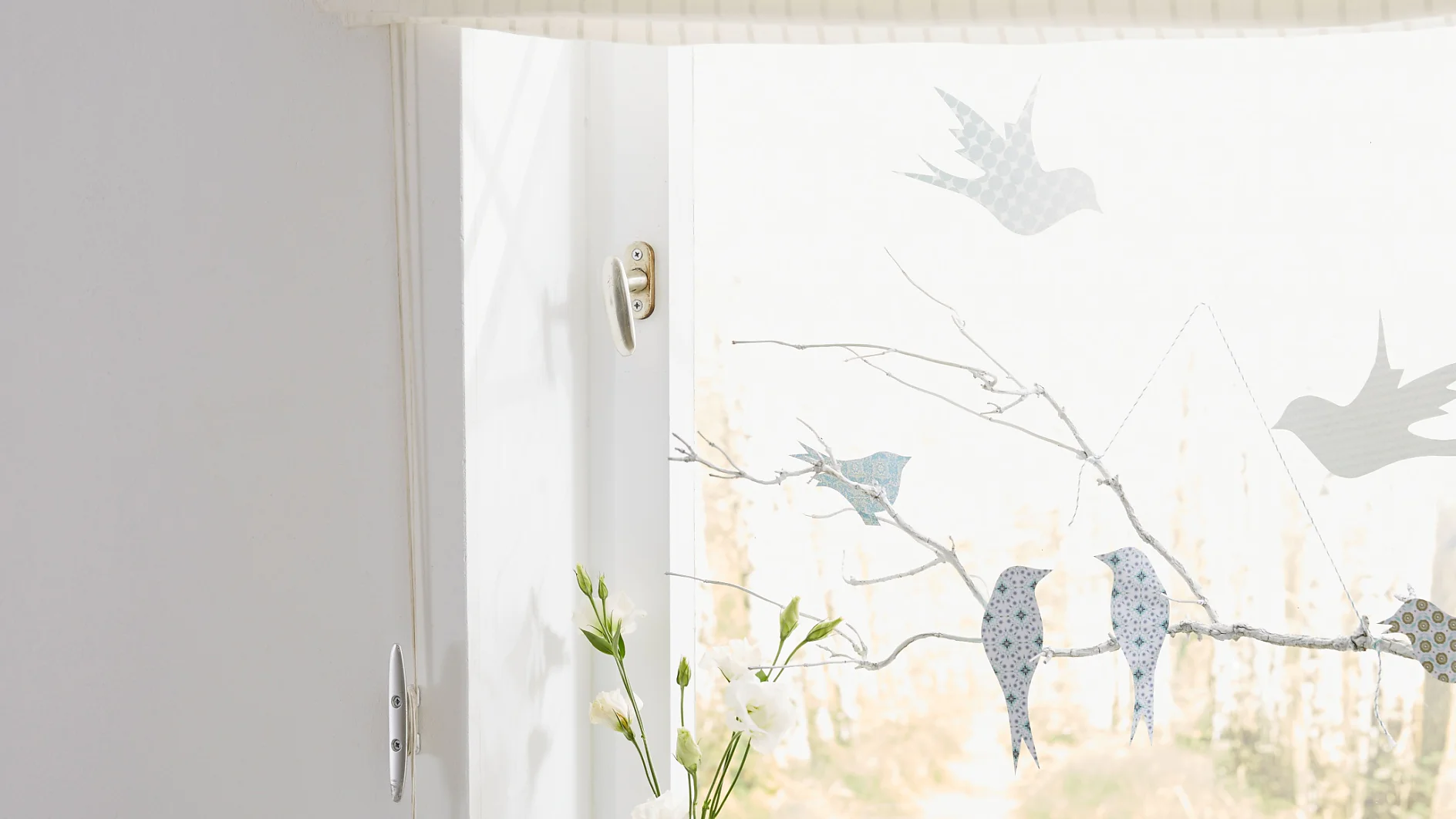 Window decoration: "Birds on branch"