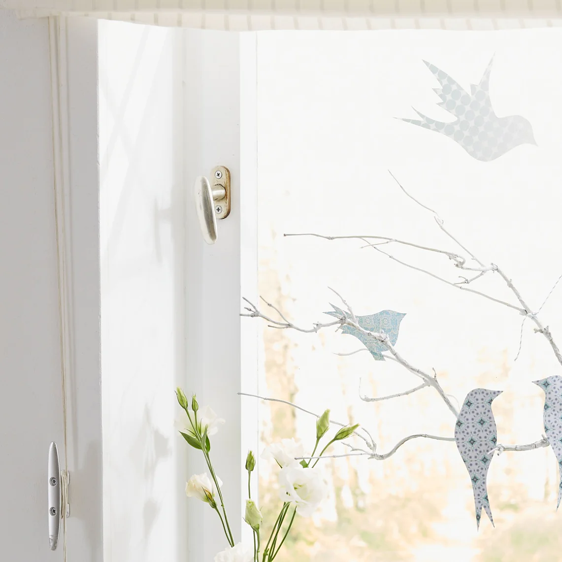 Window decoration: "Birds on branch"