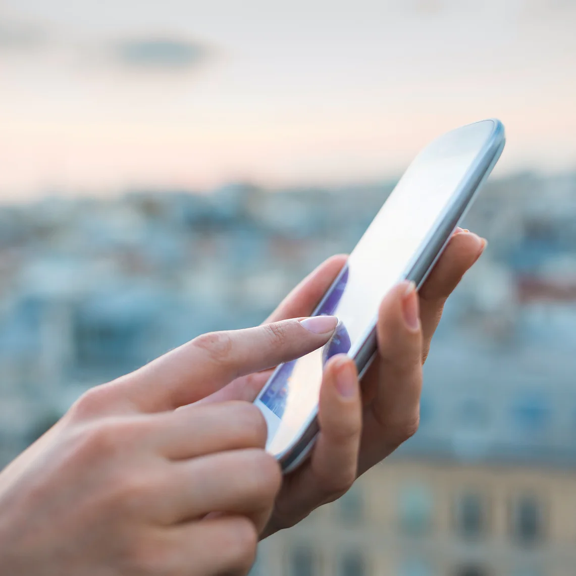 tesa woman using smartphone with city background