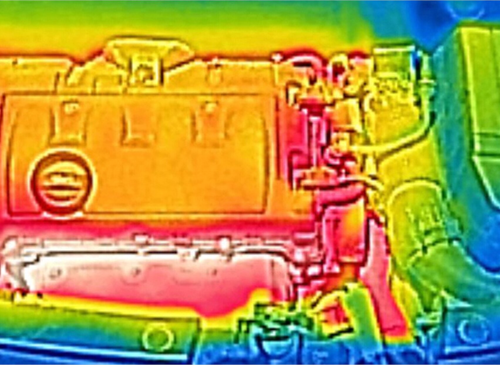 Thermal image of a car engine. The engine appears in warm colors, predominantly red and orange, indicating heat. Cooler colors, such as blue and green, surround the engine, suggesting lower temperatures in those areas. (This text has been generated by AI)