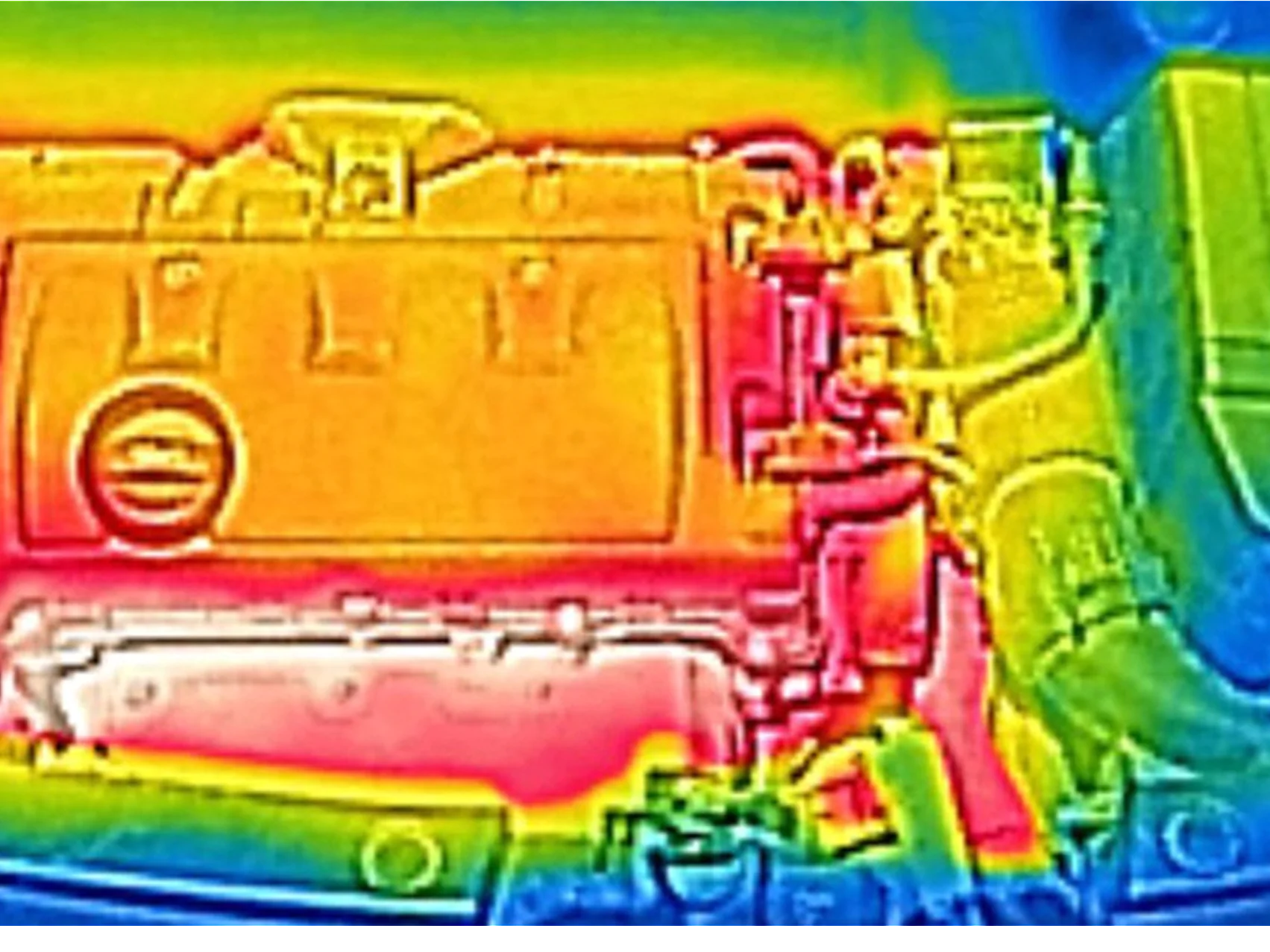 Thermal image of a car engine. The engine appears in warm colors, predominantly red and orange, indicating heat. Cooler colors, such as blue and green, surround the engine, suggesting lower temperatures in those areas. (This text has been generated by AI)