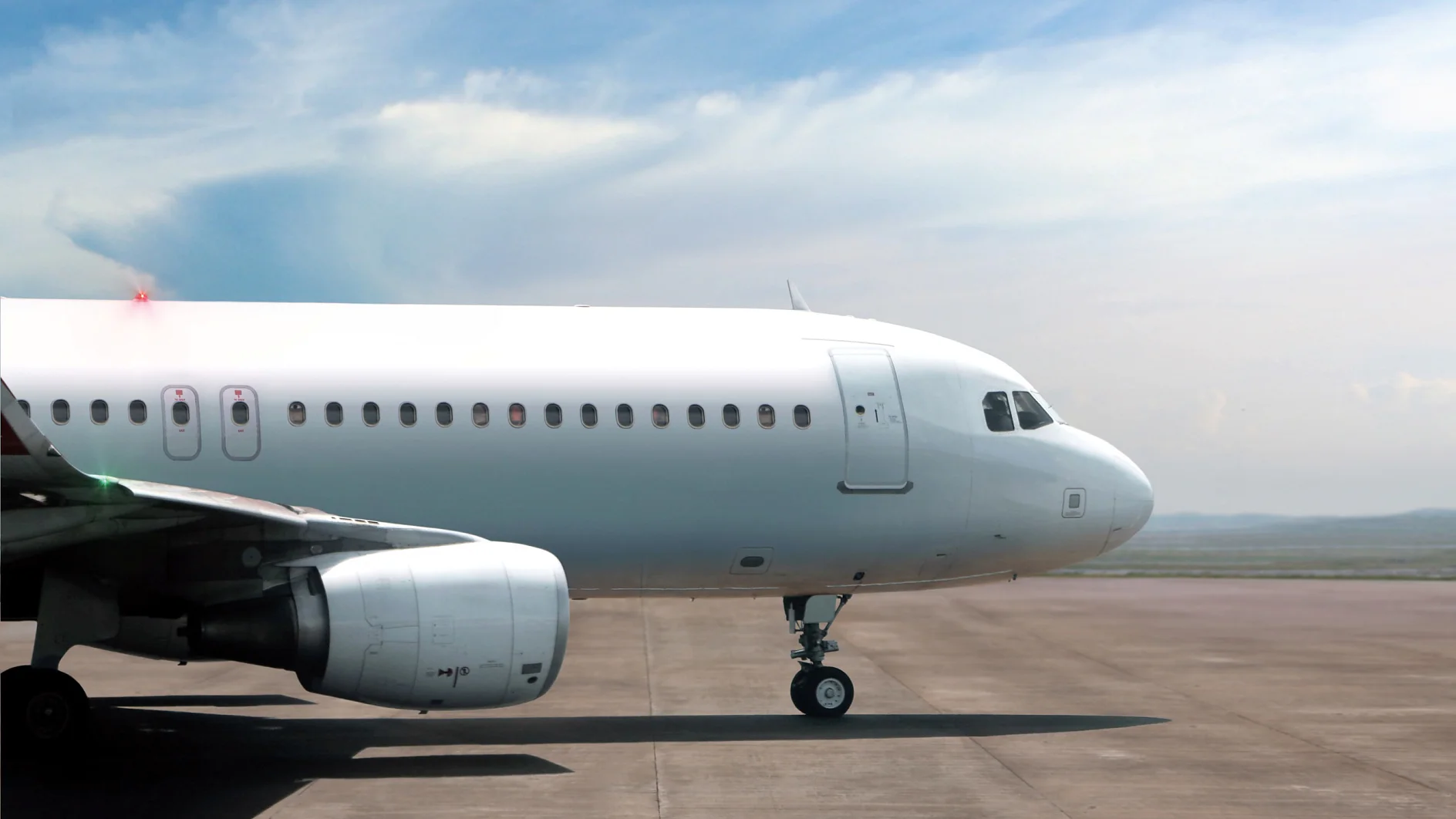 tesa airplane parked on runway under cloudy sky, showing front fuselage, cockpit, and engine on tarmac (This text has been generated by AI)