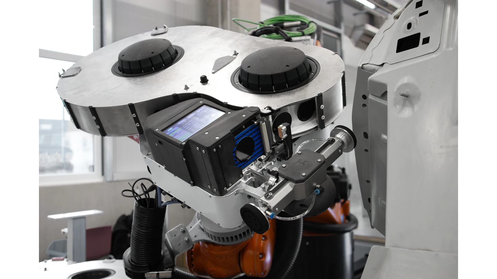 robotic arm with precision tools operating in a clean, indoor industrial setting, focusing on automated manufacturing tasks (This text has been generated by AI)