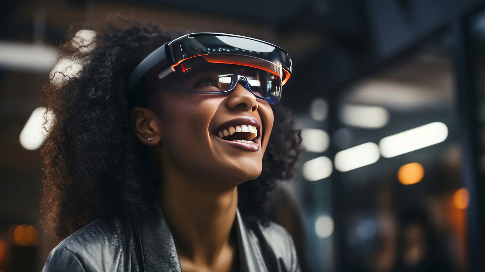 A person with curly hair smiles while wearing a futuristic augmented reality headset secured with tesa tape in a modern indoor setting with blurred lights in the background.