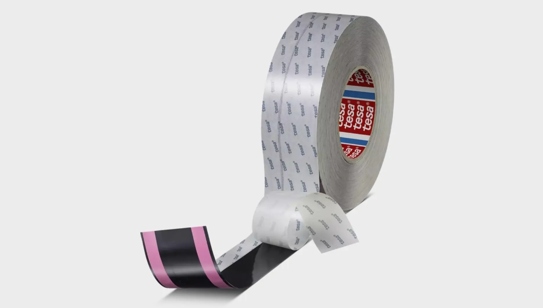 A roll of adhesive tesa tape unrolled slightly, revealing two strips. The outer strip is white with blue text, while the inner strip is black with a pink section. The tesa tape is branded with the tesa logo. (This text has been generated by AI)