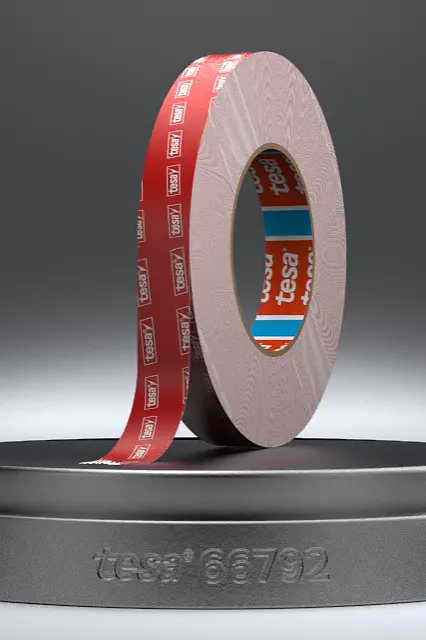 A roll of red adhesive tesa tape is displayed upright on a circular black stand against a gradient gray background. The tesa tape features white text on its surface. (This text has been generated by AI)