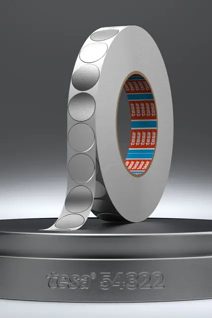A futuristic ring-like object is displayed on a round pedestal, secured with tesa tape. The object features circular patterns on its surface and reveals intricate red and blue electronic components inside. The pedestal has Intel 5822 engraved on it. The background is muted gray. (This text has been generated by AI)
