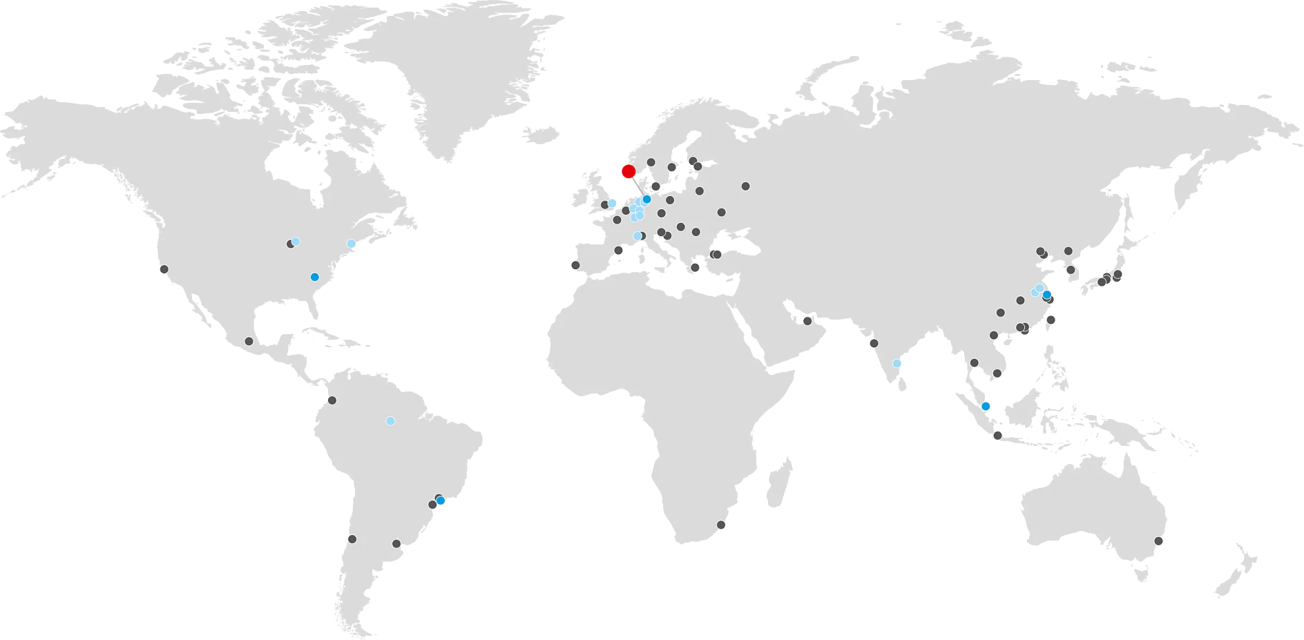A world map featuring gray continents on a black background. Small gray and blue dots are scattered across the map, with a larger red dot in Northern Europe. (This text has been generated by AI)