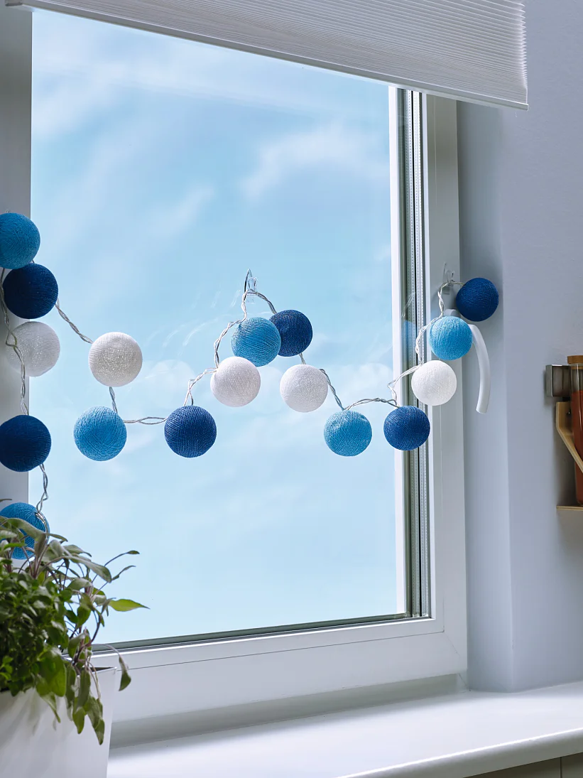 Transparent and nearly invisible adhesive hooks for mounting decorative objects on windows or mirrors.