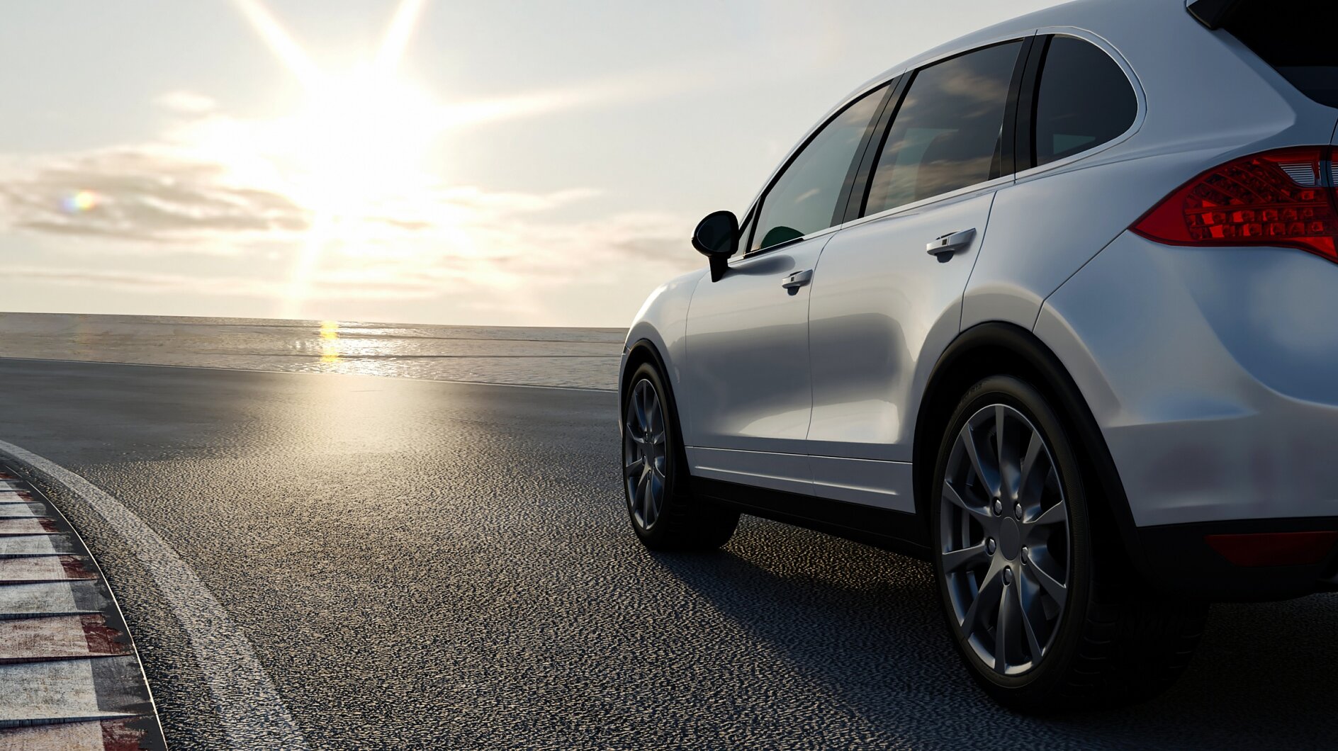 A white SUV is parked on a road near the ocean, with the sun low in the sky, creating a bright and reflective atmosphere. The car is positioned to the right, and the coastline is visible in the background. (This text has been generated by AI)