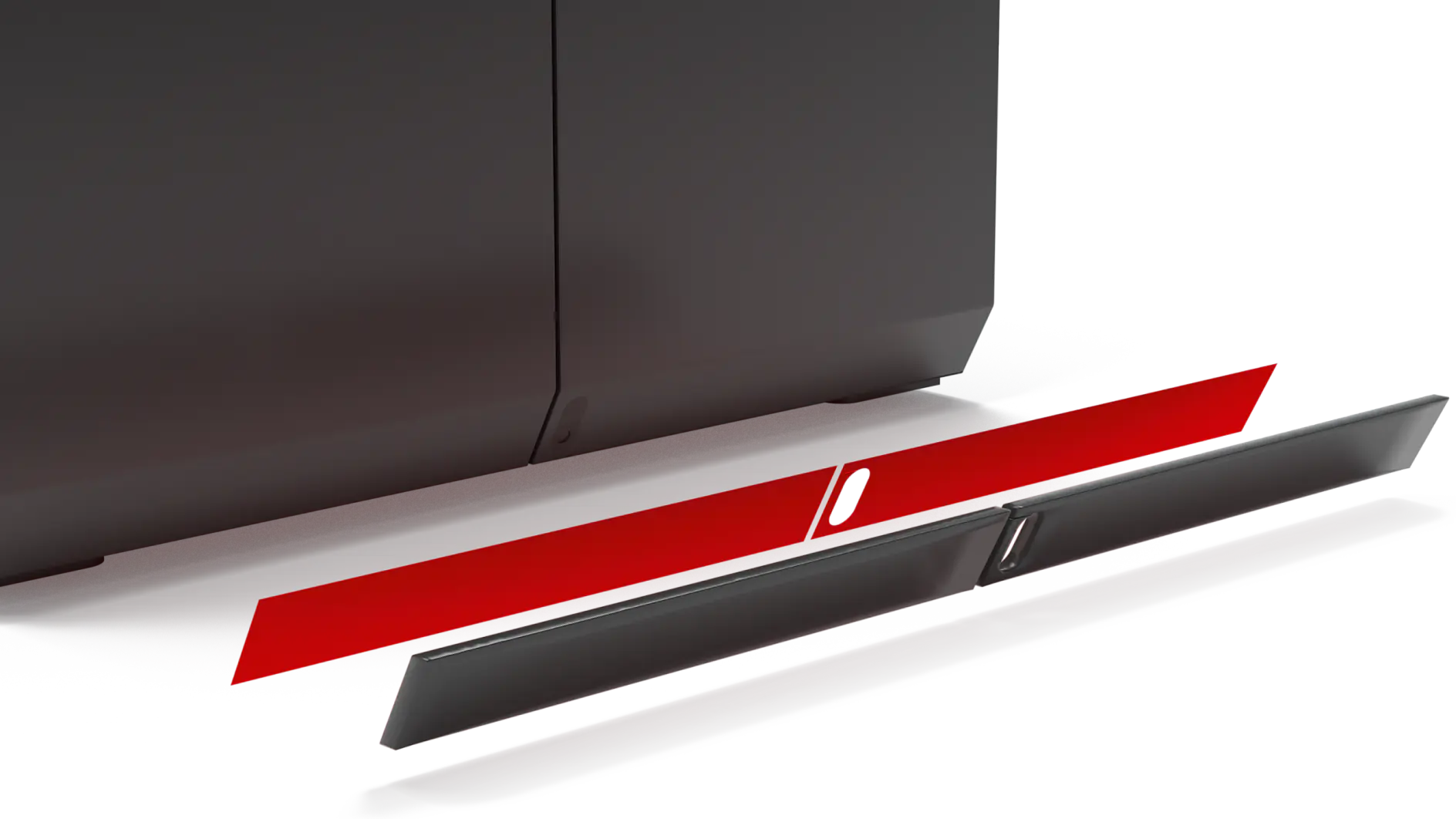 A red panel is partially detached from a gray, metallic surface. There are grooves and slots visible on the panel and the surface, indicating attachment points or connectors. The background is plain and unobtrusive. (This text has been generated by AI)